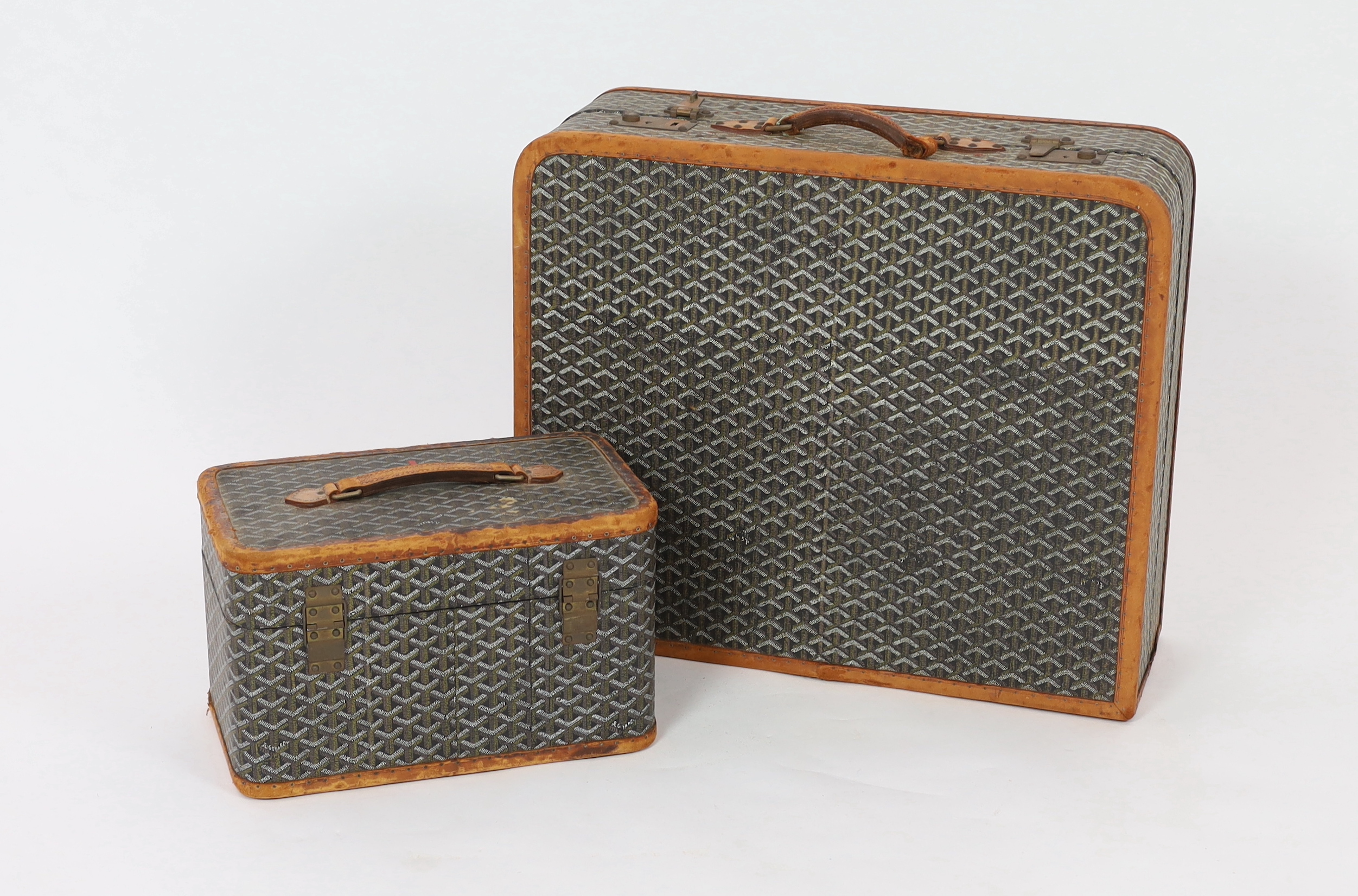 A 1940's Goyard vanity case with matching suitcase, vanity case 37cm wide, 23cm deep, 23cm high; suitcase 59cm wide, 21cm deep, 50cm high